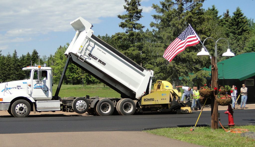 Crew with truck pouring pavement